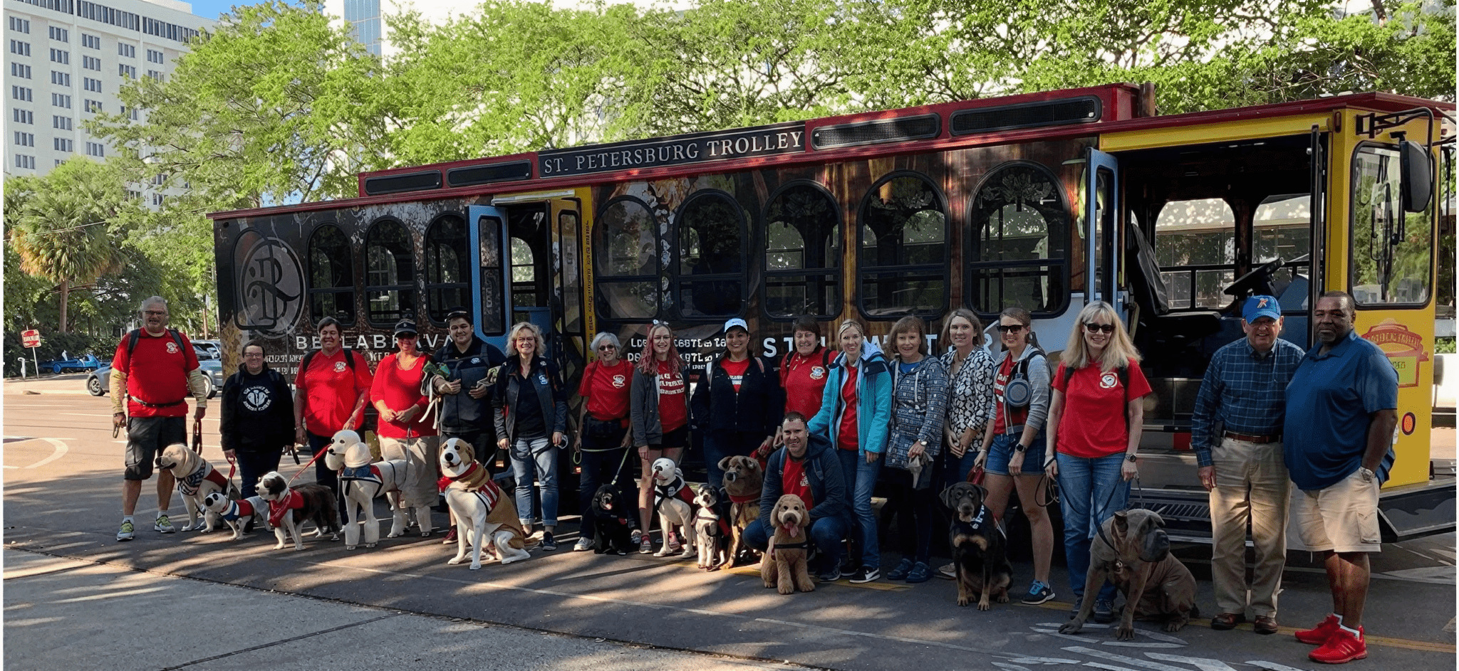 Group with dogs in front of trolley.