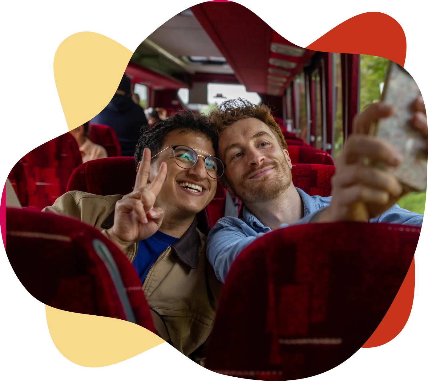 Two friends taking a selfie on bus.