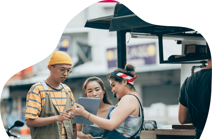 Group of friends looking at a tablet.